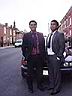Both brothers Mo and Nur standing infront BMW on their grandmother's street